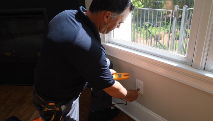 Technician Testing Outlet Technician Testing Outlet