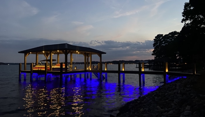 Zoomed Out View Of Boat Dock At Dusk Zoomed Out View Of Boat Dock At Dusk